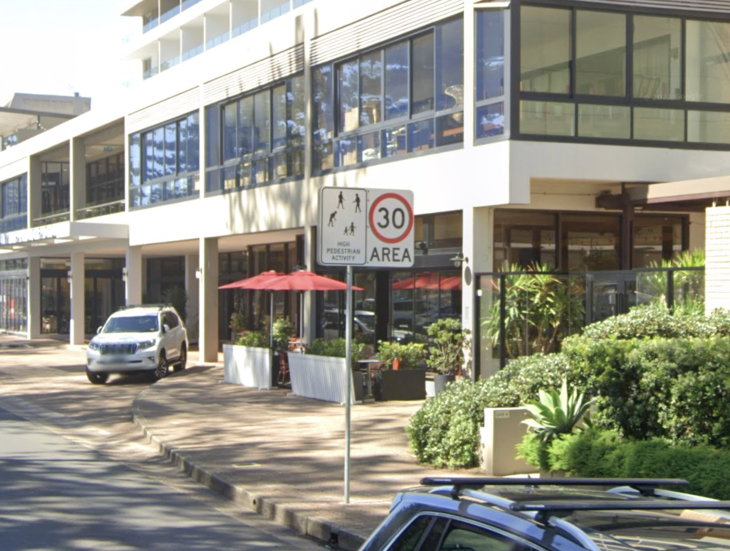 30 km/h speed limit sign in Manly, on a street outside a building